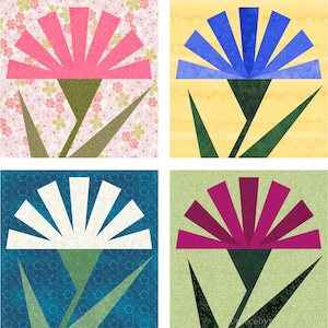 May include: Four different paper pieced flower blocks. The top left block is pink with a pink and white floral background. The top right block is blue with a yellow background. The bottom left block is white with a blue background. The bottom right block is purple with a green background.