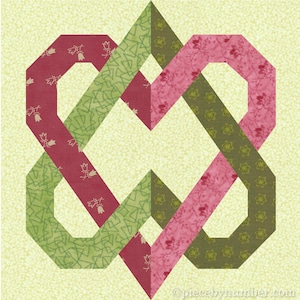 Puede incluir: Un patrón de bloque de colcha con un diseño de corazones entrelazados en tonos de verde, rosa y rojo.