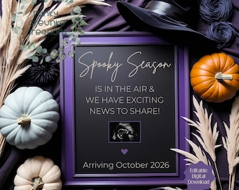 May include: A Halloween-themed announcement with a purple frame, pumpkins, and a witch's hat. The text reads "Spooky Season" and announces exciting news, with an ultrasound image and the arrival date of October 2026. Decorative elements include pampas grass.
