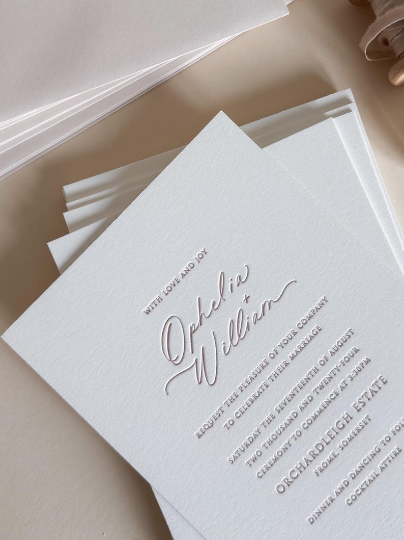 Letterpress wedding invitation with script font, in dusty rose pink tones