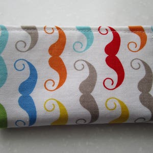 May include: A white fabric wallet with a colorful mustache pattern. The mustaches are in shades of blue, green, orange, red, and gray.