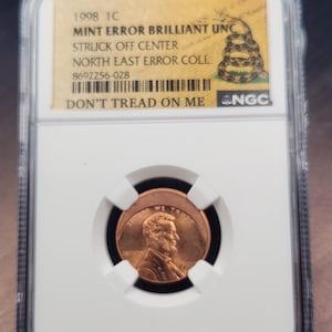 May include: A set of three ceramic mugs with a speckled, matte finish. The mugs are in shades of cream, light gray, and dark gray. Each mug has a simple, minimalist design, perfect for coffee or tea.