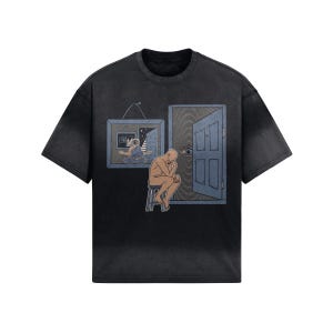 May include: Black t-shirt with a graphic print of a man sitting on a stool, looking at a door with an eye in it. The door is in a frame, and there is another frame with a picture of a person inside.