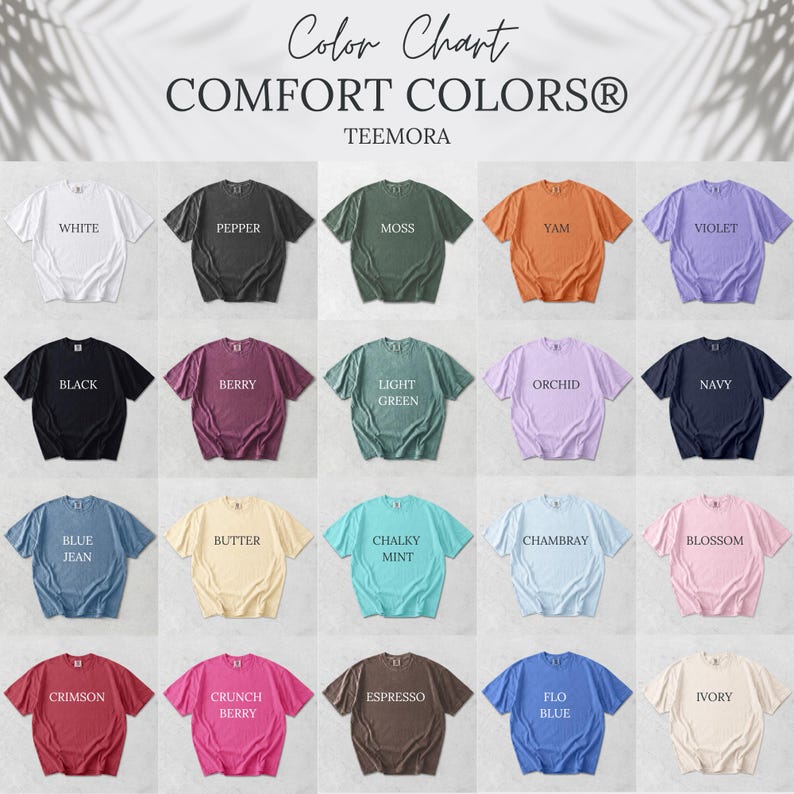May include: A color chart of Comfort Colors t-shirts in various hues, including white, black, and navy. The chart displays the colors with the names of each color printed on the shirts. The brand name "TEEMORA" is also visible.