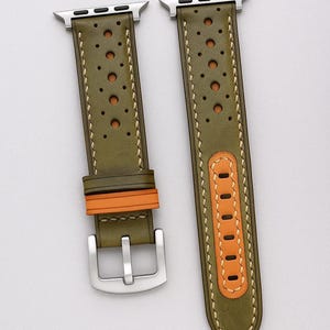 May include: Olive green leather watch band with perforated detailing and tan accents. The band features a silver buckle and is shown with a silver Apple Watch. The text "No:4" is visible in the lower left corner.