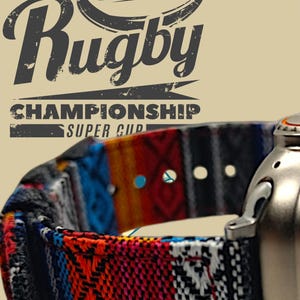 May include: A close-up of a colorful patterned watch band with the words "Rugby Championship Super Cup" in a distressed font. The band features a mix of red, blue, orange, and black geometric designs. A silver watch component is visible on the right.