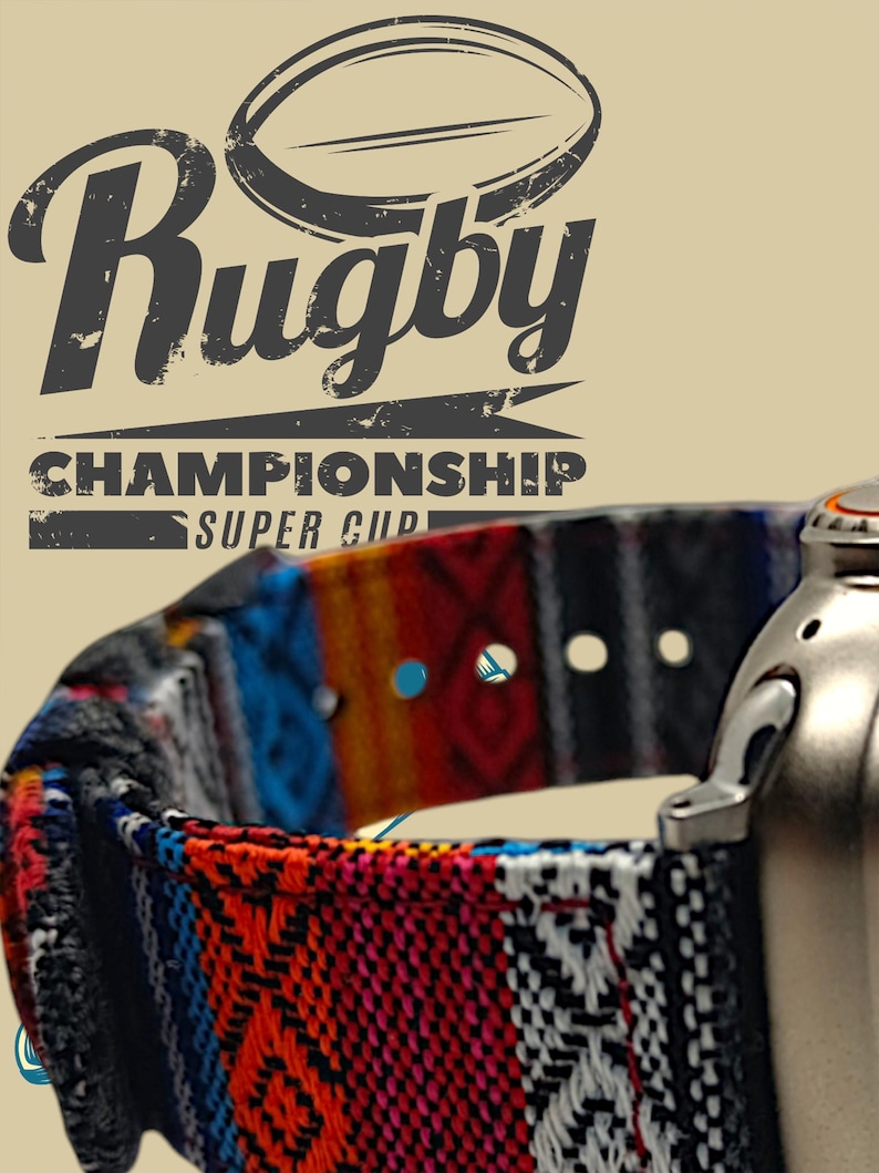 May include: A close-up of a colorful patterned watch band with the words "Rugby Championship Super Cup" in a distressed font. The band features a mix of red, blue, orange, and black geometric designs. A silver watch component is visible on the right.