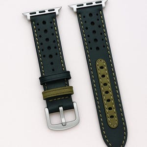 May include: Black leather watch band with perforated detailing and olive green accents. The band features a silver buckle and is shown with a silver smartwatch. The text "No:2" is visible.