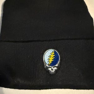 May include: Black knit beanie with a Grateful Dead Steal Your Face logo patch.