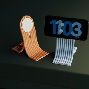 Könnte beinhalten: Zwei Telefonständer, einer orange und einer blau, mit einem weißen Kreis auf dem orangen Ständer und einem Telefon mit einer blauen Digitaluhr, die 11:03 anzeigt, auf dem blauen Ständer.