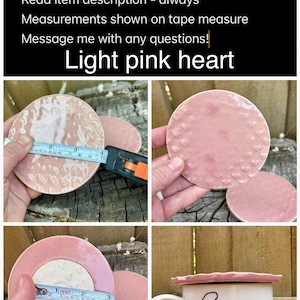 May include: A set of circular light pink ceramic lids featuring various embossed patterns, including small hearts and textured surfaces. A measuring tape shows a diameter of approximately 3.5 inches. One lid is shown placed on top of a white ceramic mug.