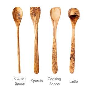 May include: Four wooden kitchen utensils: a kitchen spoon, spatula, cooking spoon, and ladle. Each is made of olive wood, showcasing a natural wood grain pattern. The text below each utensil identifies its function.
