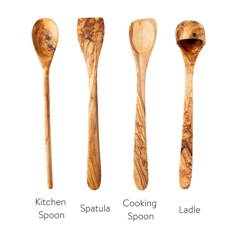 May include: Four wooden kitchen utensils: a kitchen spoon, spatula, cooking spoon, and ladle. Each is made of olive wood, showcasing a natural wood grain pattern. The text below each utensil identifies its function.