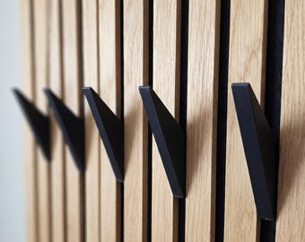 Wedge hooks for acoustic panels can be mounted without drilling or gluing.