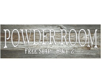 May include: A rustic wooden sign with the text "POWDER ROOM - FREE SOAP - MINT 2¢" in white lettering.