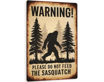 May include: A vintage-style metal sign with a warning about feeding the Sasquatch. The sign features a silhouette of Bigfoot walking through a forest with the text "WARNING! PLEASE DO NOT FEED THE SASQUATCH".