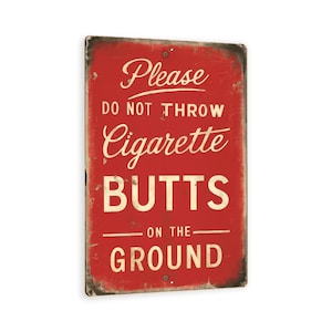 May include: Red metal sign with white text that reads "Please do not throw cigarette butts on the ground".