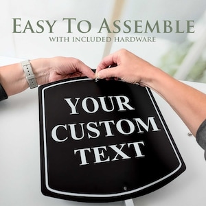 May include: A black sign with white text that reads "YOUR CUSTOM TEXT". The sign has a white border and is being assembled. The text "EASY TO ASSEMBLE" is above the sign.
