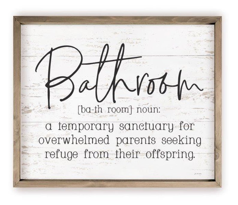 May include: A white wooden sign with a black inscription that reads "Bathroom [ba-th room] noun: a temporary sanctuary for overwhelmed parents seeking refuge from their offspring."