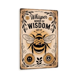 May include: A rectangular metal sign with a vintage design. The sign features a large bee with flower accents, surrounded by floral and leaf motifs. The text "Whisper Words of Wisdom Let It" is displayed in a decorative font.
