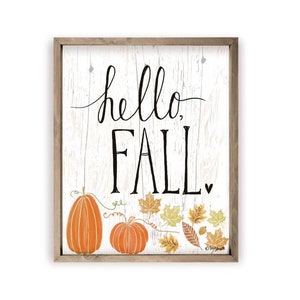 May include: A framed wood sign with a white background and the text "hello, fall."  The sign is decorated with two orange pumpkins and fall leaves.