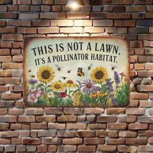 May include: A metal sign with a rustic background featuring a variety of flowers and butterflies. The sign reads "This is not a lawn. It's a pollinator habitat."