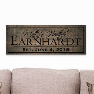 May include: A rustic wooden sign with the text "Matt & Heather Earnhardt Est. June 4, 2016" in black lettering.