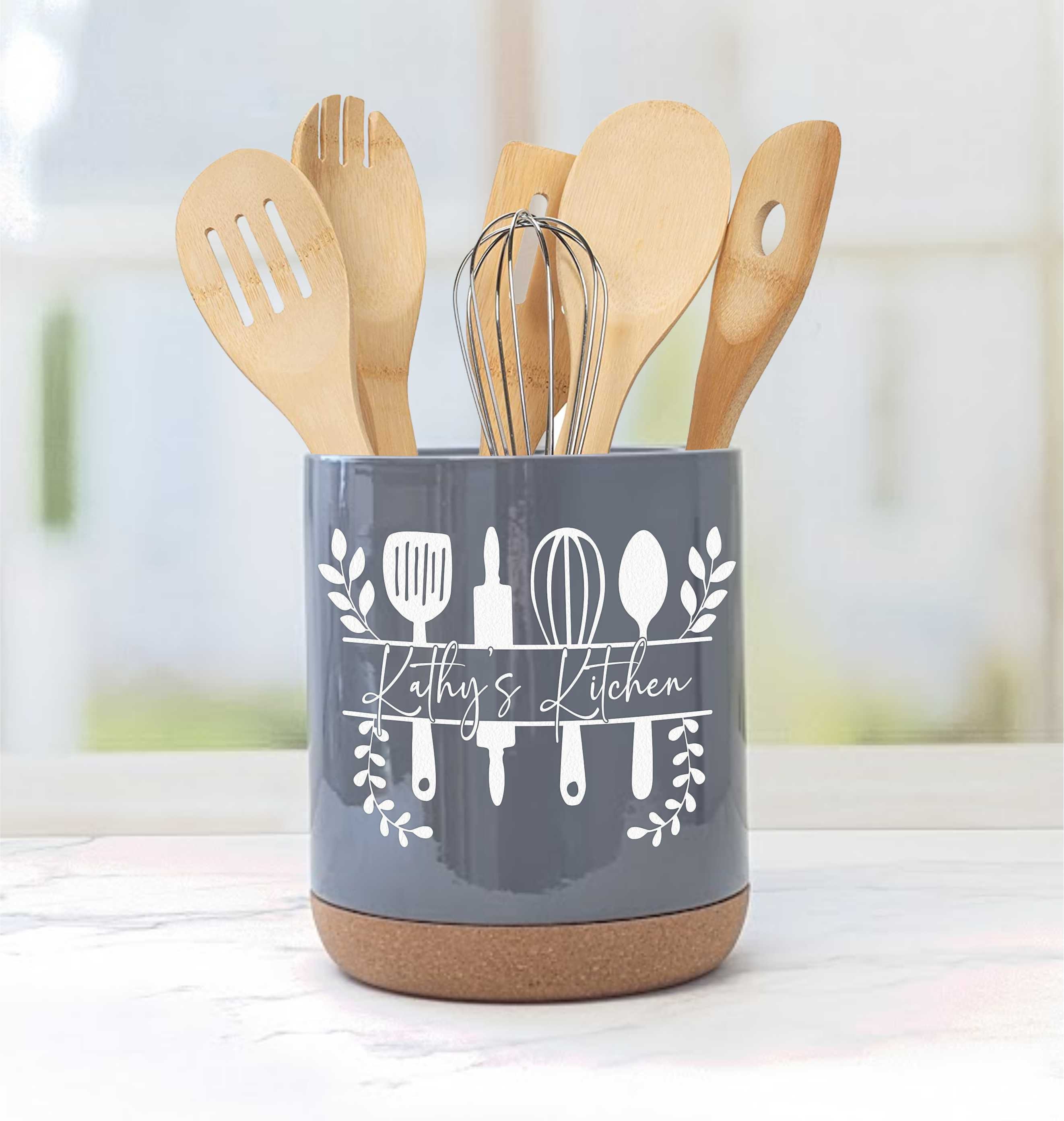 White ceramic utensils and kitchen utensils on a wooden countertop