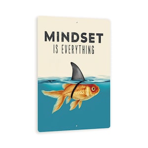 May include: A motivational metal sign with a gold fish wearing a shark fin. The sign reads "Mindset is Everything".