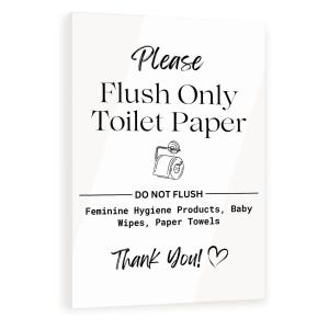 May include: White rectangular sign with black text that reads "Please Flush Only Toilet Paper." Below, it says "DO NOT FLUSH" followed by a list of items. The sign ends with "Thank You!" and a heart symbol.