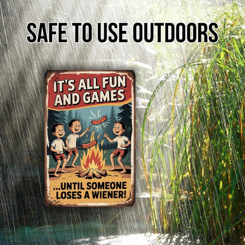 May include: A rectangular metal sign with the text "SAFE TO USE OUTDOORS" at the top. The sign features a cartoon illustration of three boys roasting hot dogs over a campfire, with the text "IT'S ALL FUN AND GAMES...UNTIL SOMEONE LOSES A WIENER!"