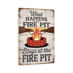 May include: Wooden sign with the text "What happens at the FIRE PIT stays at the FIRE PIT." The sign features a brick fire pit with flames and marshmallows on sticks. The background has a wood grain texture and a brown mountain range.