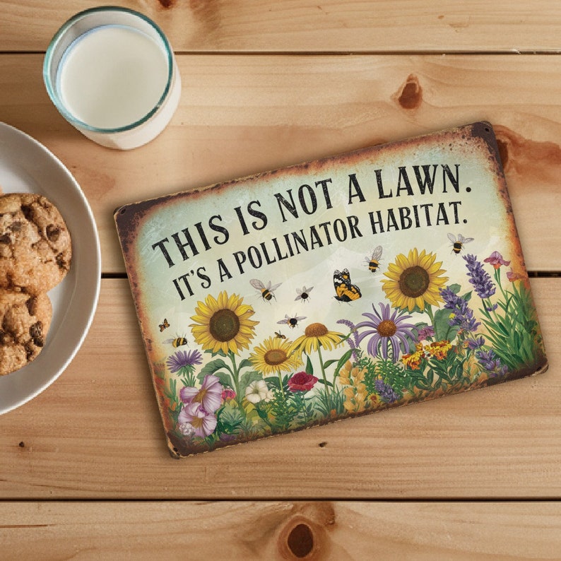 May include: A rustic metal sign with the text "This is not a lawn. It's a pollinator habitat."  The sign features a colorful illustration of a garden with various flowers, butterflies, and bees.