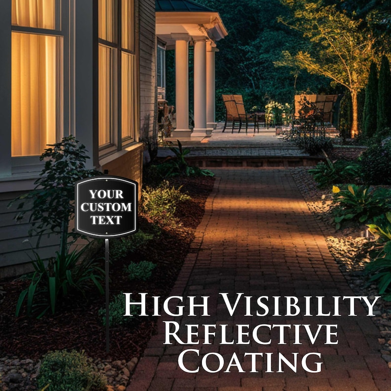 May include: A black and white sign with the text "YOUR CUSTOM TEXT" is displayed on a metal stake. The sign is in front of a house with a brick pathway. The sign also has the text "HIGH VISIBILITY REFLECTIVE COATING".