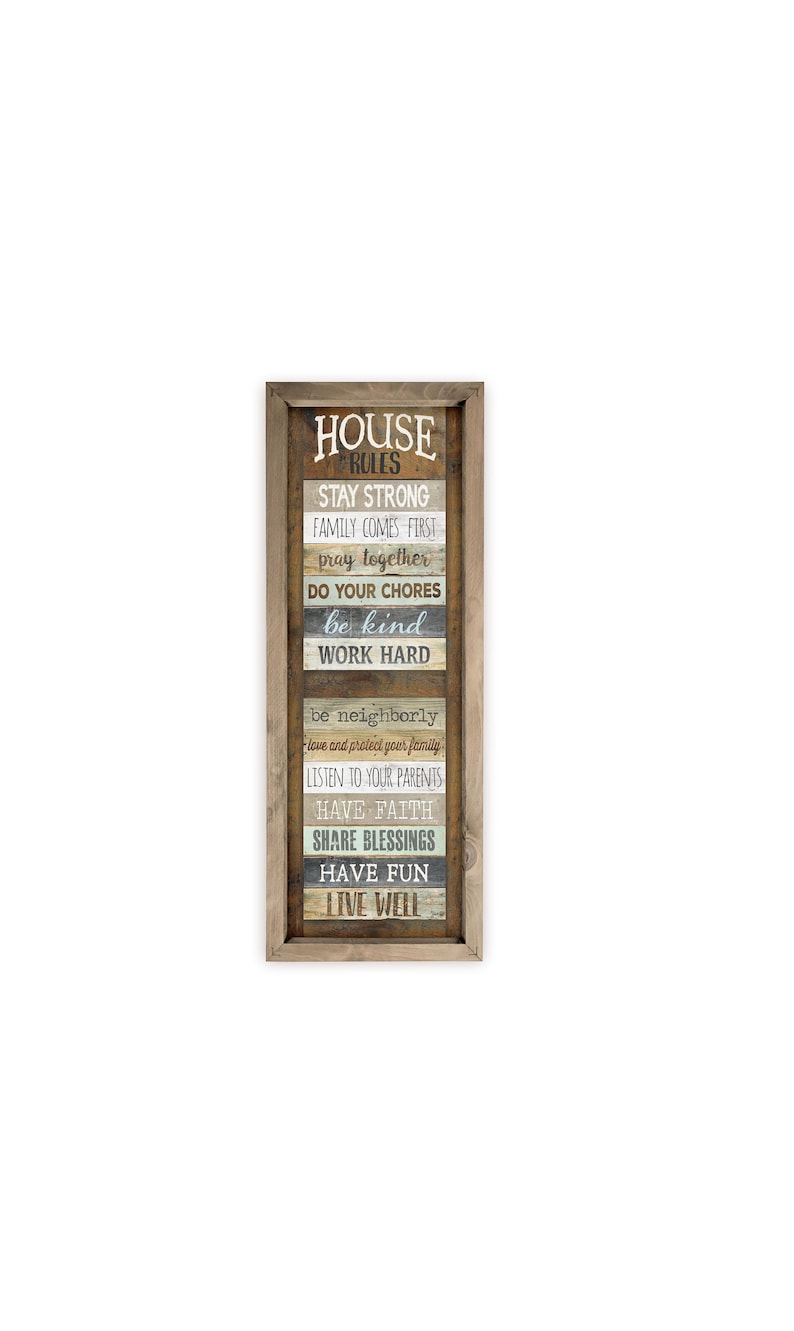 May include: A framed wooden sign with the text "HOUSE RULES" and a list of rules for a family home, including "Stay Strong", "Family Comes First", "Pray Together", "Do Your Chores", "Be Kind", "Work Hard", "Be Neighborly", "Listen To Your Parents", "Have Faith", "Share Blessings", "Have Fun", and "Live Well".