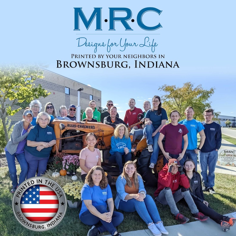 May include: Group photo in front of an orange tractor. The text at the top says "M.R.C Designs for Your Life" and "PRINTED BY YOUR NEIGHBORS IN BROWNSBURG, INDIANA". A circular graphic with the American flag reads "PRINTED IN THE USA BROWNSBURG, INDIANA".