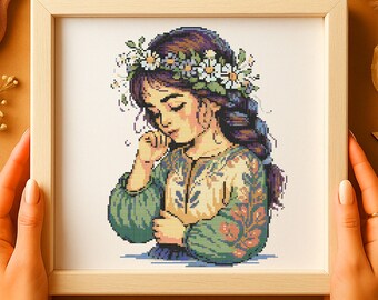 花柄のクロスステッチパターン 花の刺繍が施された思慮深い少女 野の花