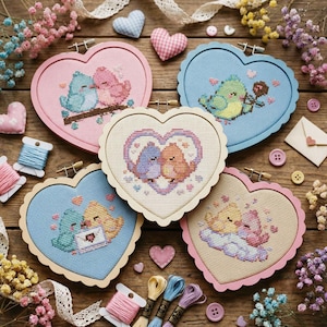 May include: Five heart-shaped cross-stitch embroidery hoops featuring colorful birds, surrounded by floral accents, buttons, and spools of thread. The hoops are in shades of pink, blue, and natural wood, with various bird designs.