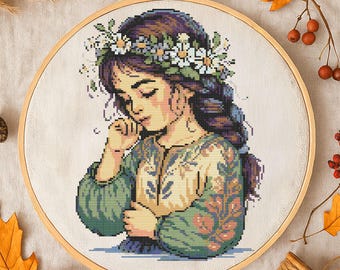 花柄のクロスステッチパターン 花の刺繍が施された思慮深い少女 野の花