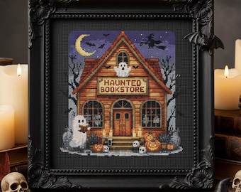 May include: Cross-stitch art of a haunted bookstore in a black frame. The building is brown with a sign that reads "Haunted Bookstore". Ghosts, pumpkins, and a witch on a broom are also featured in the design. A bat decorates the frame.