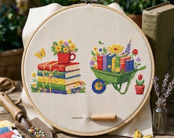 May include: Cross-stitch embroidery hoop with a design of books, flowers, and a wheelbarrow. The design includes a stack of books with a red teacup and a wheelbarrow filled with books and flowers. A vintage book is in the background.
