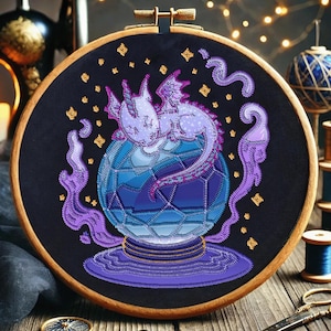 May include: Purple and blue embroidered dragon curled around a crystal ball with gold accents and purple smoke. The embroidery is on a black fabric in a wooden hoop.