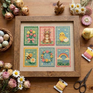 May include: A framed cross-stitch sampler with six postage stamp designs, depicting spring and Easter motifs. The designs include a bouquet, a bunny, a chick, a bee, a floral wreath, and a rainbow. The wooden frame surrounds the sampler.