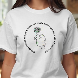 May include: White t-shirt with a quirky cartoon design. The design shows a small character with a thought bubble containing a colourful, abstract pattern. Text encircles the design, reading "Can you repeat the part about the stuff where you said all of the things."