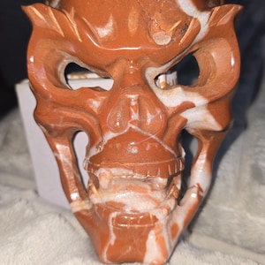Hand-Carved Red Jasper Skull Mask – 6x4 in Polished Stone Carving, Crystal Decor