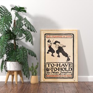 May include: A framed vintage poster with the title "TO HAVE & TO HOLD" by Mary Johnston. The poster features a black and white illustration of two figures dueling with swords. The poster is in a wooden frame.