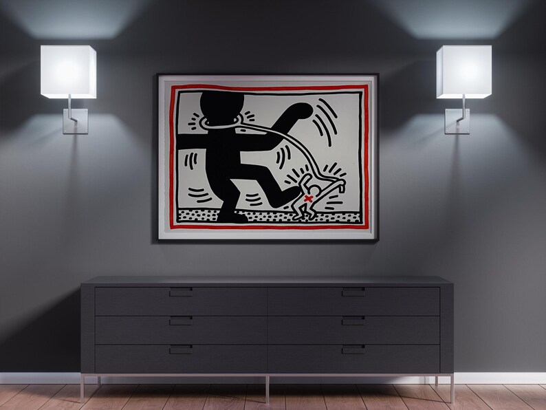 May include: A framed artwork featuring a black and white graphic of a figure with a leash, set against a red border. The artwork hangs above a dark gray dresser with six drawers, flanked by two square wall sconces.