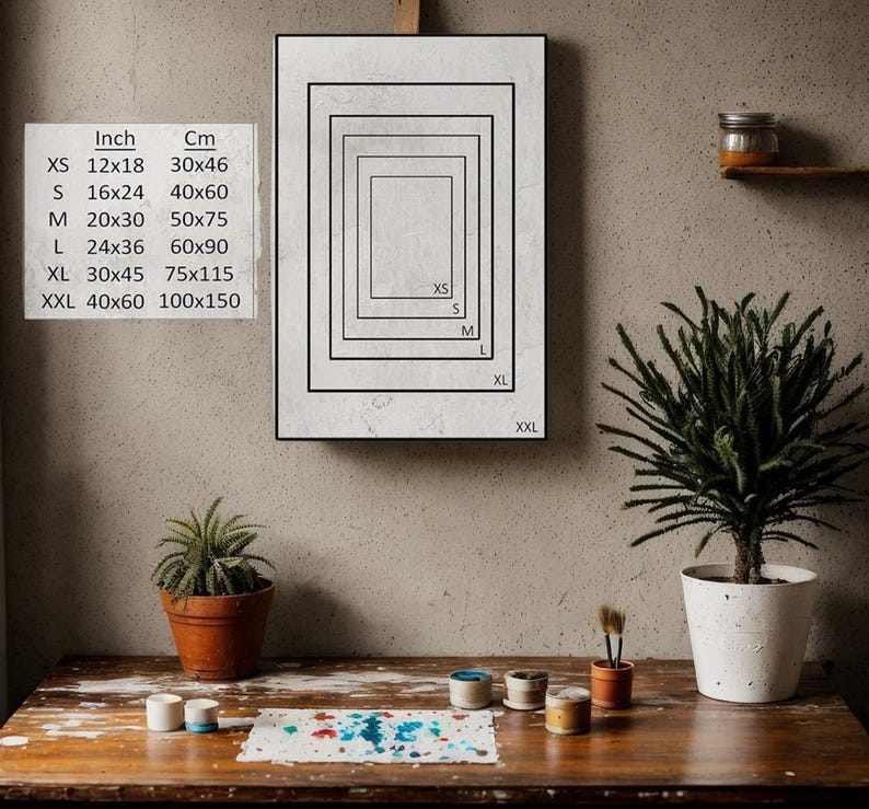 K&ouml;nnte beinhalten: Ein gerahmtes Poster mit wei&szlig;em Hintergrund und schwarzen Linien, die verschiedene Gr&ouml;&szlig;en von Rechtecken umrei&szlig;en. Das Poster zeigt die Abmessungen jedes Rechtecks in Zoll und Zentimetern. Der Text auf dem Poster lautet: "Inch Cm XS 12x18 30x46 S 16x24 40x60 M 20x30 50x75 L 24x36 60x90 XL 30x45 75x115 XXL 40x60 100x150".