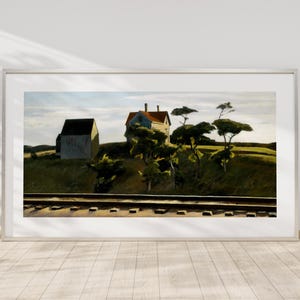 May include: Framed landscape art print featuring a rural scene with a house, barn, trees, and railroad tracks. The artwork has a muted color palette with a focus on natural elements. The print is displayed in a white frame.