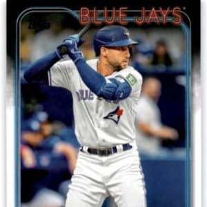 May include: A baseball card depicting George Springer of the Toronto Blue Jays. The card has a blue and white border, with the words "BLUE JAYS" in red at the top. Springer is in a white uniform with blue accents and a blue helmet, holding a bat.